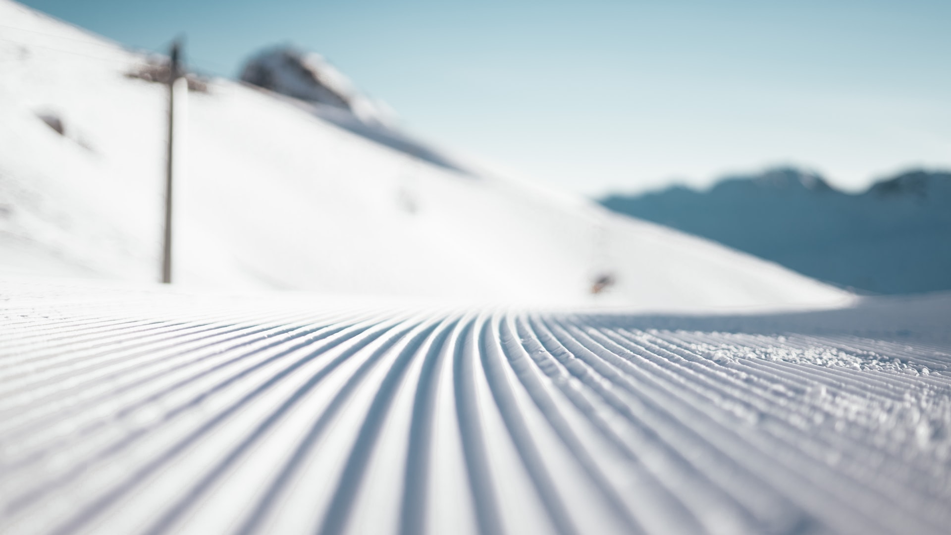 freshly groomed ski slope piste zoom background